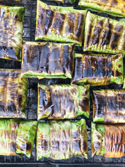The food is wrapped in banana leaves, grilled on the stove, ready-to-eat food, beautifully arranged.lifestyle.