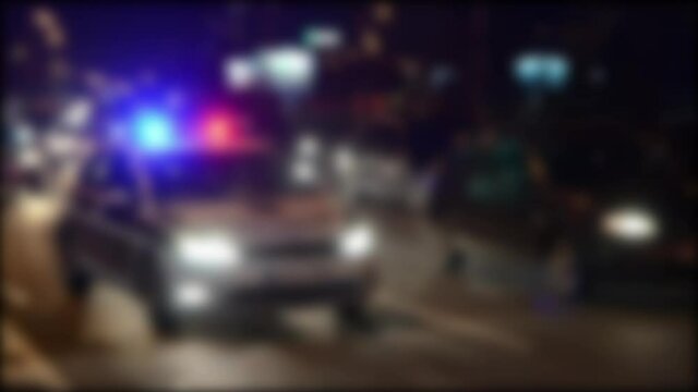 Blurred blue and red lights on patrol car. Police lights flash at night. Crime scene. Car accident and traffic jam. 