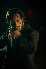 killer aims at the victim