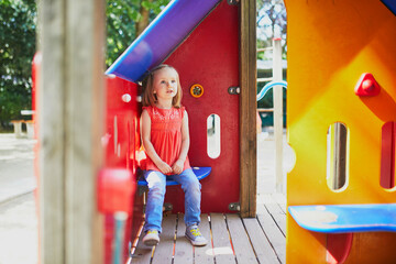 Adorable little girl on playground on a sunny day