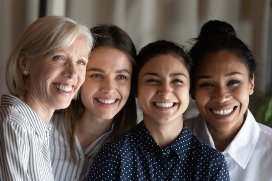 Head shot portrait smiling diverse businesswomen colleagues showing unity, standing in row, happy coworkers employees office workers posing for corporate photo, employment and recruitment concept