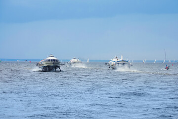 Sea routes, navigation. Meteor hydrofoil jet boats and sailboats in Baltic sea bay of St. Petersburg, Russia