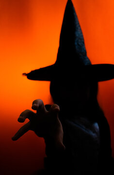 Silhouette of little witch on Halloween