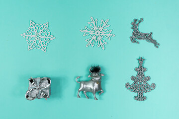 White and silver Christmas decorations on a blue background, top view, flat lay. Christmas mood. The basis for the postcard.