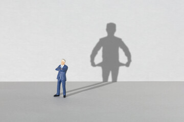 Poor businessman. Shadow of a businessman with empty pockets inside out. Crisis or bankruptcy...