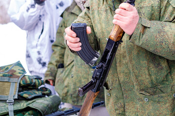 Fototapeta premium a military man holds a disassembled machine gun in his hands
