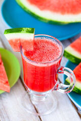 Delicious healthy refreshing low calories summer drink: watermelon smoothie or juice. Concept of seasonal desserts, detox, dieting. White wooden background, close up, macro