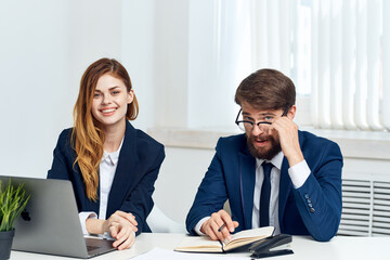 business man and woman work together in front of laptop professionals technology