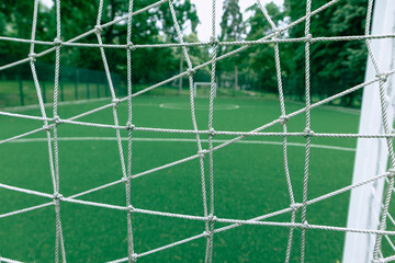 The net in front of the soccer field. Soccer goal net