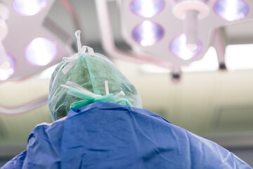 Operierender Arzt in steriler OP Kleidung bei einer Operation im Krankenhaus