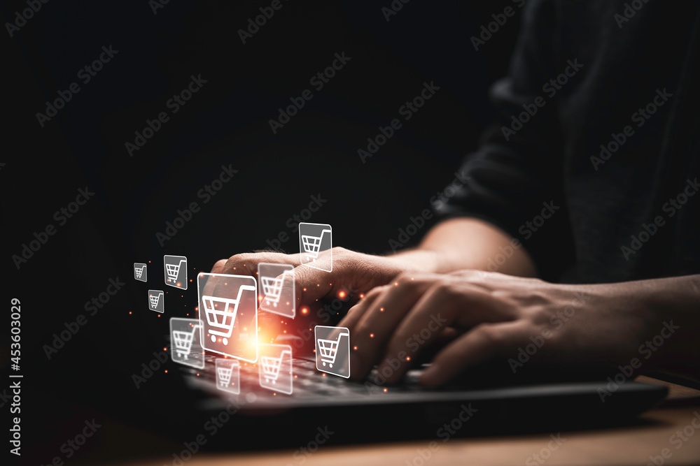 Aufkleber businessman using computer laptop with shopping trolley cart icon for input order for online shoppin