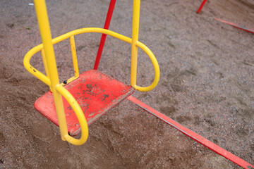 child's metal swing on the street close up