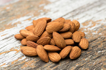 Almond dried fruits on an old wooden background.