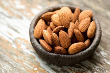 Almond dried fruits on an old wooden background.