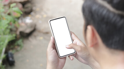 Man's hands holding or using smartphone with two hands. Smartphone with white blank on screen, Cellphone mockup.