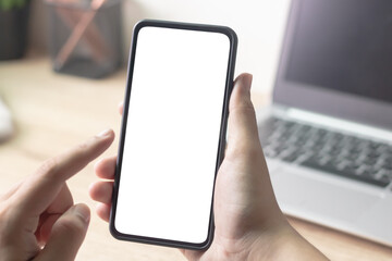 Man's hands holding or using smartphone with two hands. Smartphone with white blank on screen, Cellphone mockup.