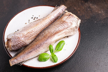 hake raw white fish seafood fresh portion ready to eat meal snack on the table copy space food background rustic. top view keto or paleo diet food pescetarian 