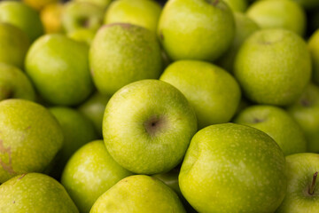 appetizing green apples on counter in market