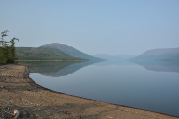 Putorana Plateau. Fog on a mountain lake.