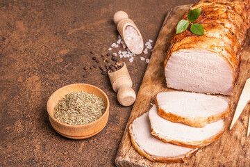 Homemade baked pork tenderloin on stone concrete background
