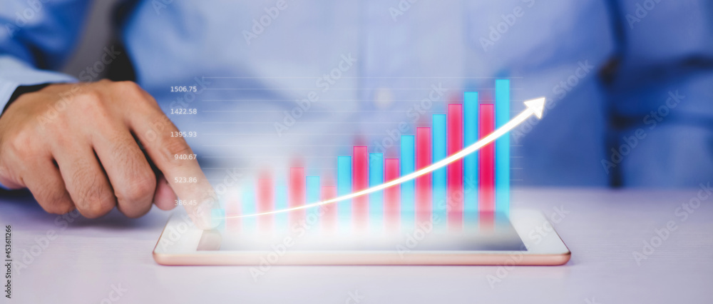 Poster businessman touch tablet computer with graph and chart of investment and finance, growth of stock an
