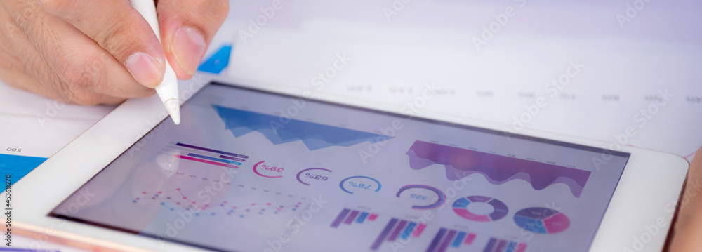 Poster businessman planning about graph and chart of investment with report for finance on tablet computer 
