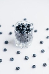 Beautiful ripe blueberries in a transparent glass glass on a white background. Healthy food, and vitamins.
