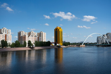 Nur-Sultan, Kazakhstan, July 2021. View from the Atyrau bridge to the Ishim River and tall buildings. High quality photo