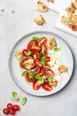 salad with tomatoes, stracciatella, ciabatta and basil