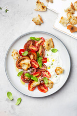 salad with tomatoes, stracciatella, ciabatta and basil