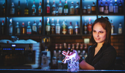 young attractive woman bartender Making Cocktail in bar