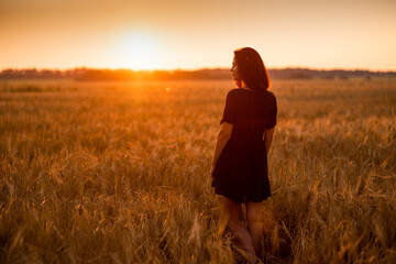 girl in a wheat field at dawn