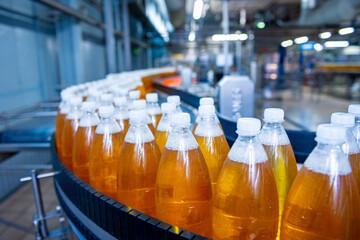 Conveyor belt with bottles for juice or water at a modern beverage plant