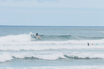 Surfer racing the foam, les casernes beach, seignosse, landes, france