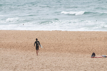 Surfer running to the waves, les casernes beach, seignosse, landes, france