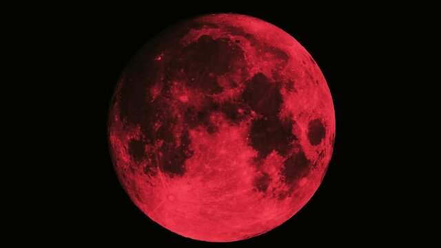 Closeup graded shot of the evil red full moon aka blood moon filmed with a super tele lens in UHD as perfect Halloween background