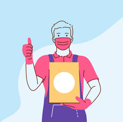 Delivery during coronavirus epidemic. Young man courier deliveryman in protective medical mask standing and holding order in box for delivery