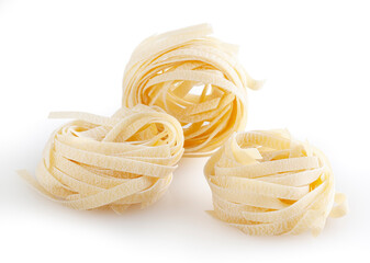 Uncooked tagliatelle pasta isolated on white background with clipping path
