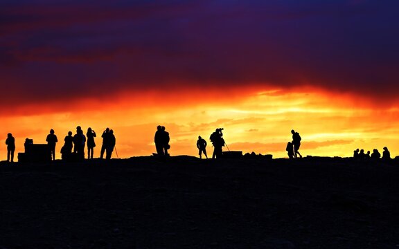 Silhouette of people standing against the sunset or sunrise at San Pedro de Atacama desert, Chile