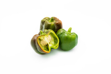 Fresh green pepper head isolated on white leaf. A variety of sweet green peppers. Sectional view.
