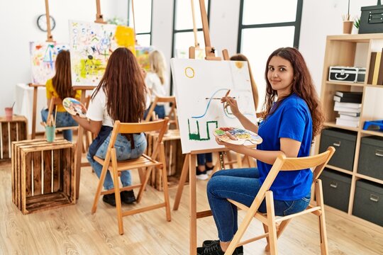 Group of young artist girls smiling happy drawing at art studio.