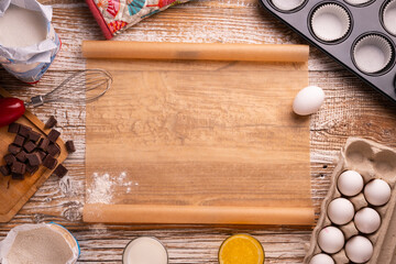 recipe for homemade chocolate muffins. utensils and ingredients for cake preparation. on a white table. ingredients for cupcakes