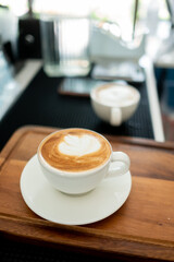 hot latte art coffee on wood table, relax time