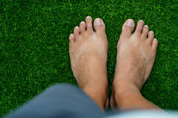 closeup feet on green grass background