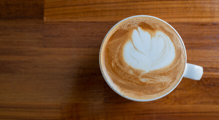 hot latte art coffee on wood table, relax time