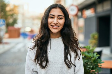 Young middle east girl smiling happy standing at the city.