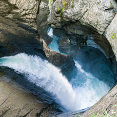 Trummelbach Waterfall in Lautenbrunnen. A glacier waterfall system located inside the mountain with...