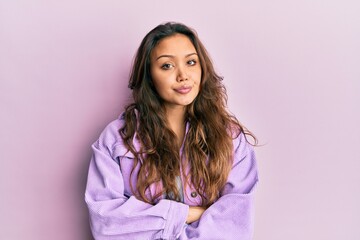 Fototapeta premium Young hispanic girl wearing casual clothes skeptic and nervous, disapproving expression on face with crossed arms. negative person.