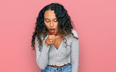 Young hispanic woman with curly hair wearing casual clothes feeling unwell and coughing as symptom for cold or bronchitis. health care concept.