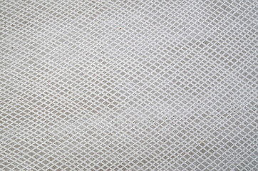 Ceramic surface with crossed parallel white lines cross close